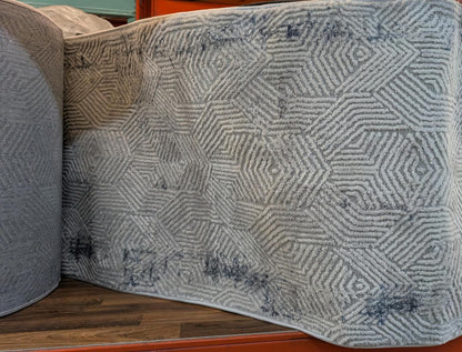 Rouleau du tapis de passage Symphoni géométrique en magasin